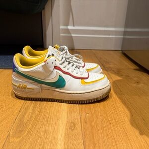 Nike AF1 Sneakers with Red and Yellow, Green and Blue accents.